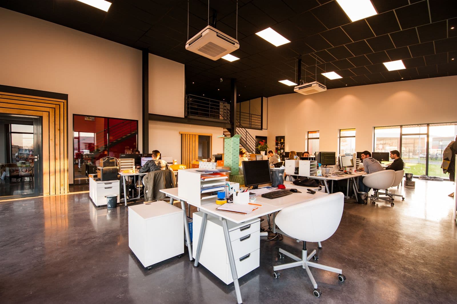 Open commercial office with polished floors and workstations