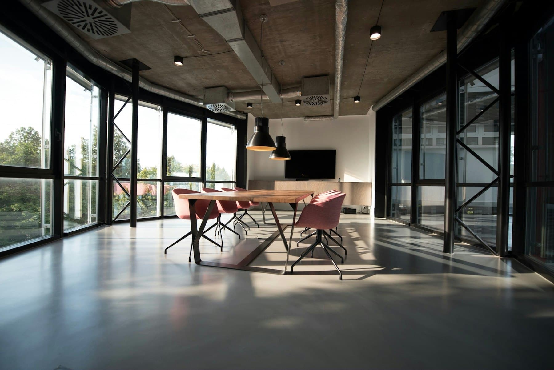 Sunlit conference room with a large polished commercial floor